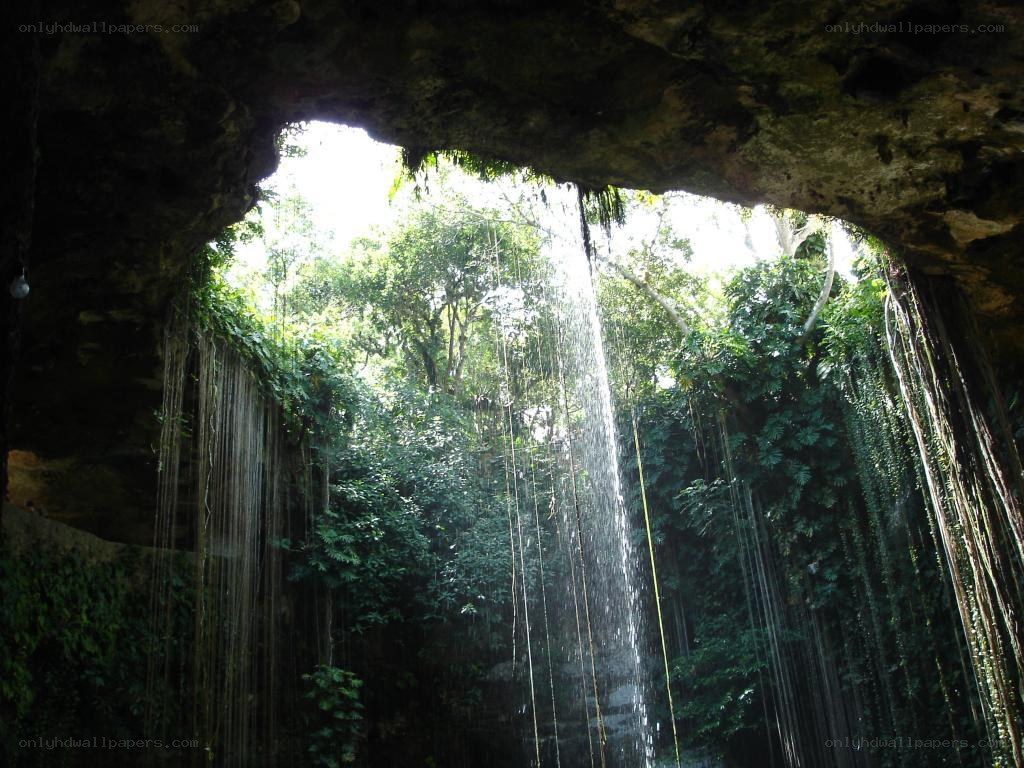 Cave waterfall in tropical forest