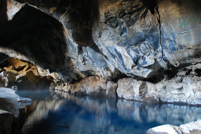 cave with blue water pool