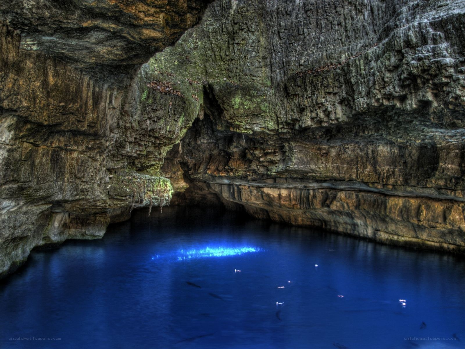 cave with glowing blue water