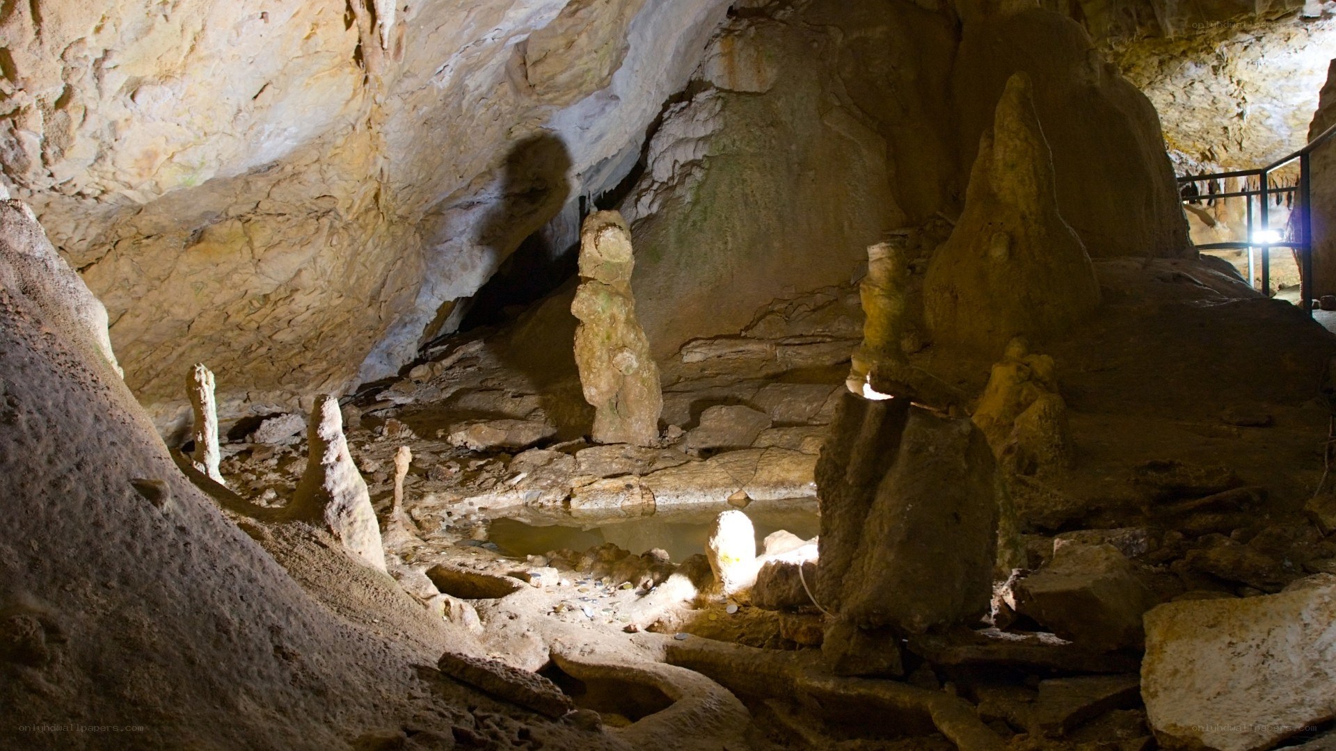 cave with stalagmites and pool