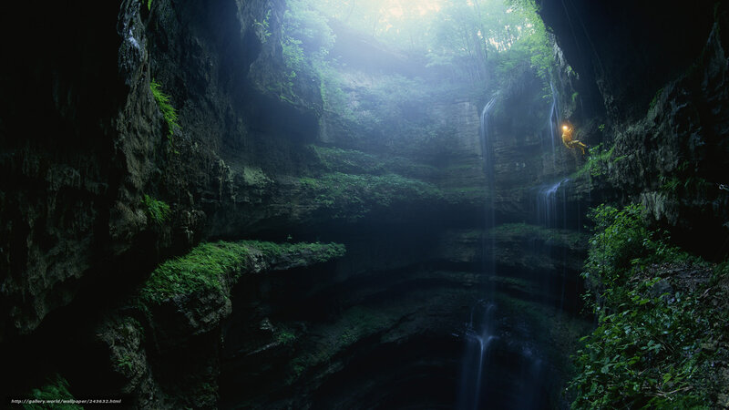 Cave with waterfall and climber