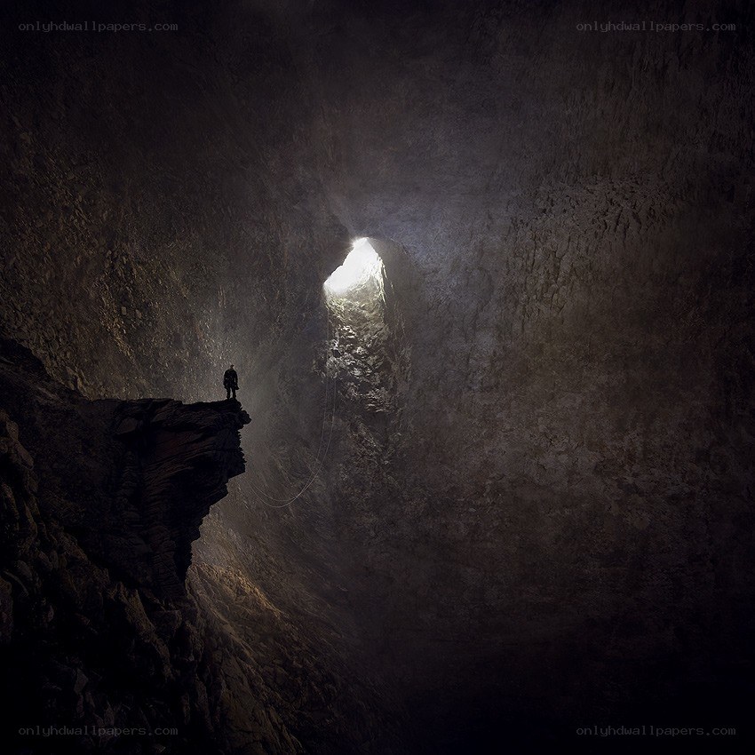 Caver at cave entrance