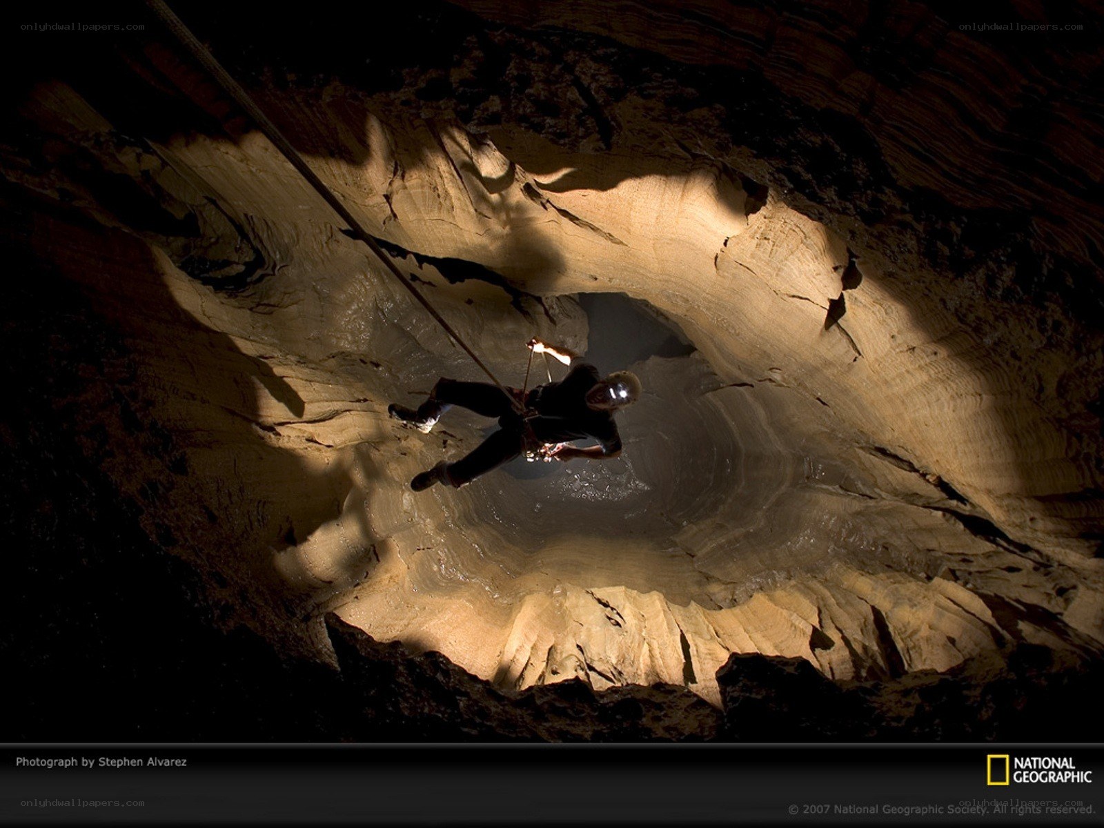 Caver descending into a cave