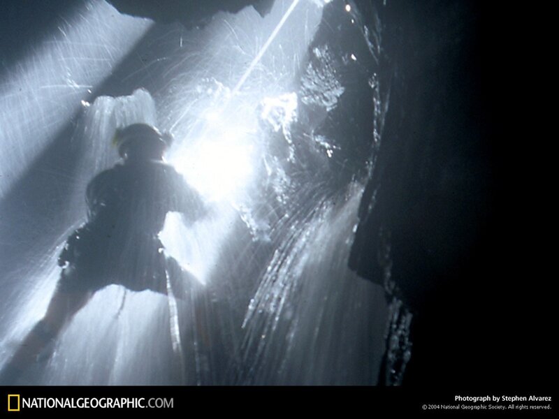 Caver in a waterfall cave