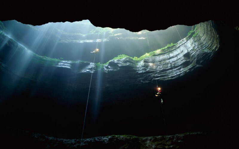 Cavers in a deep cave