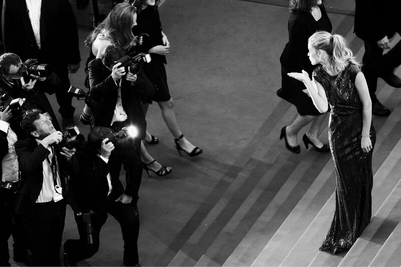 Celebrity on red carpet with photographers