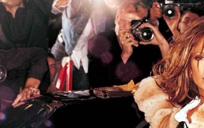 celebrity surrounded by photographers
