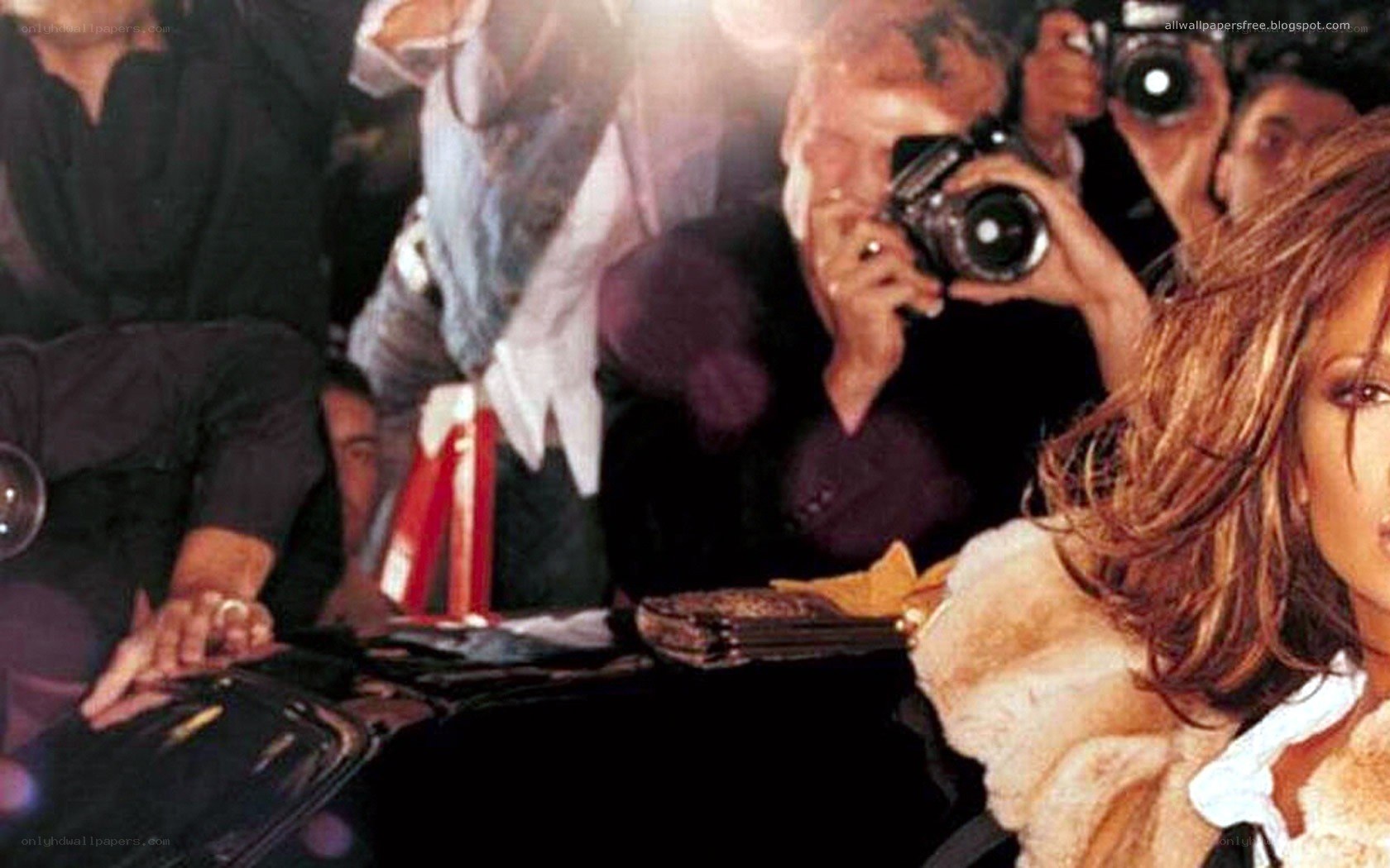 celebrity surrounded by photographers