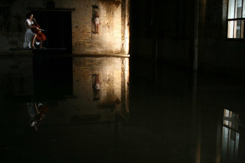 Cellist in a flooded warehouse