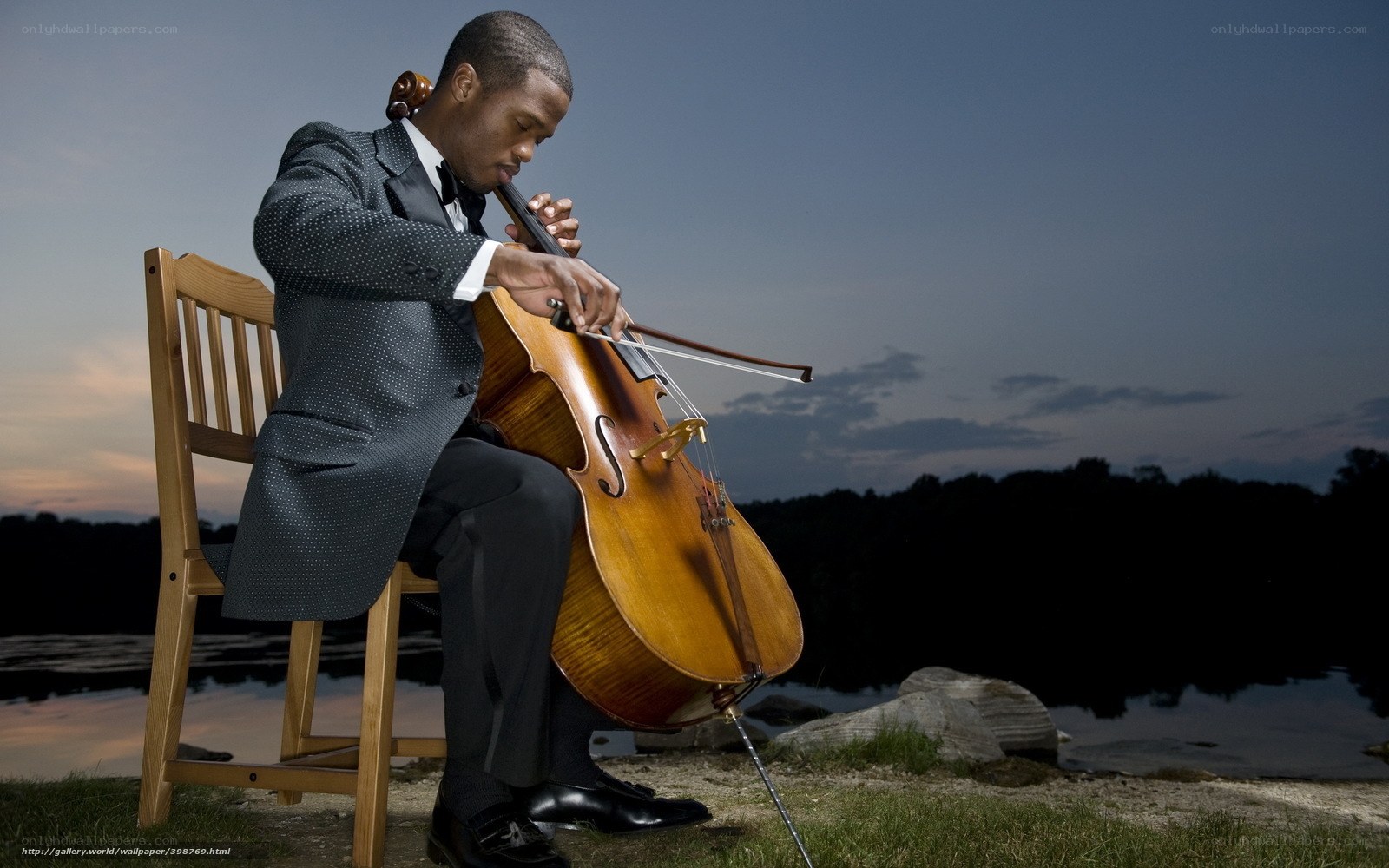 Cellist playing by the lake