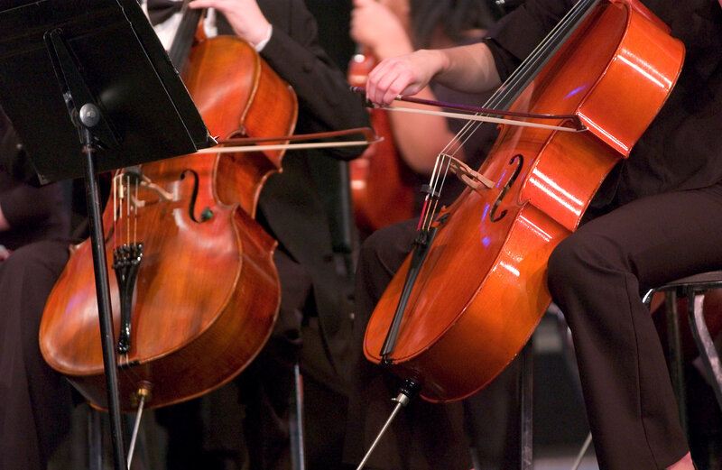 Cellists performing in orchestra