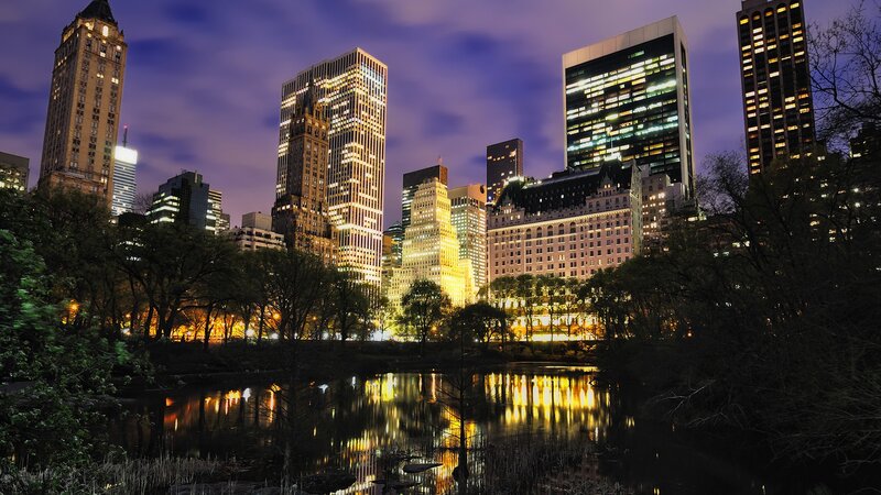 Central Park at dusk with city skyline