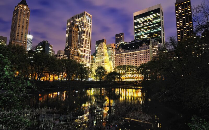 Central Park at dusk with city skyline