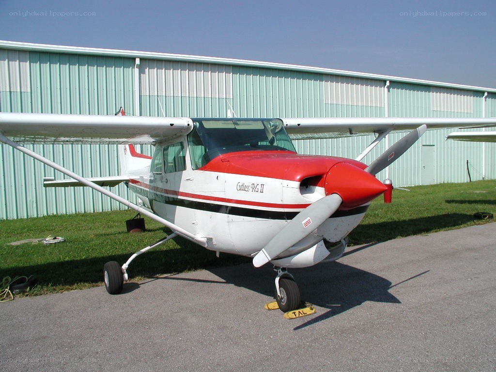 Cessna aircraft parked outside hangar