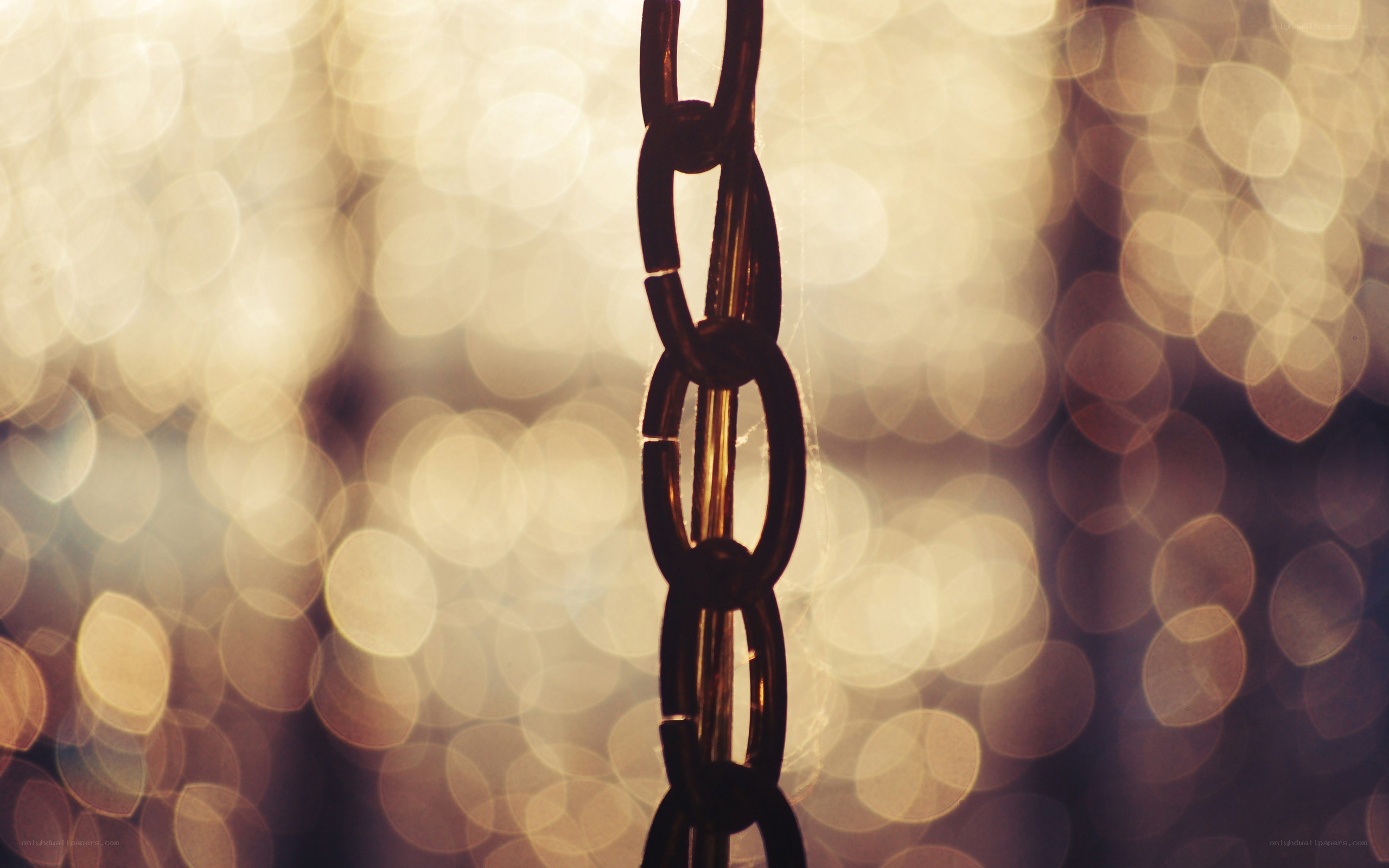 chain against bokeh lights