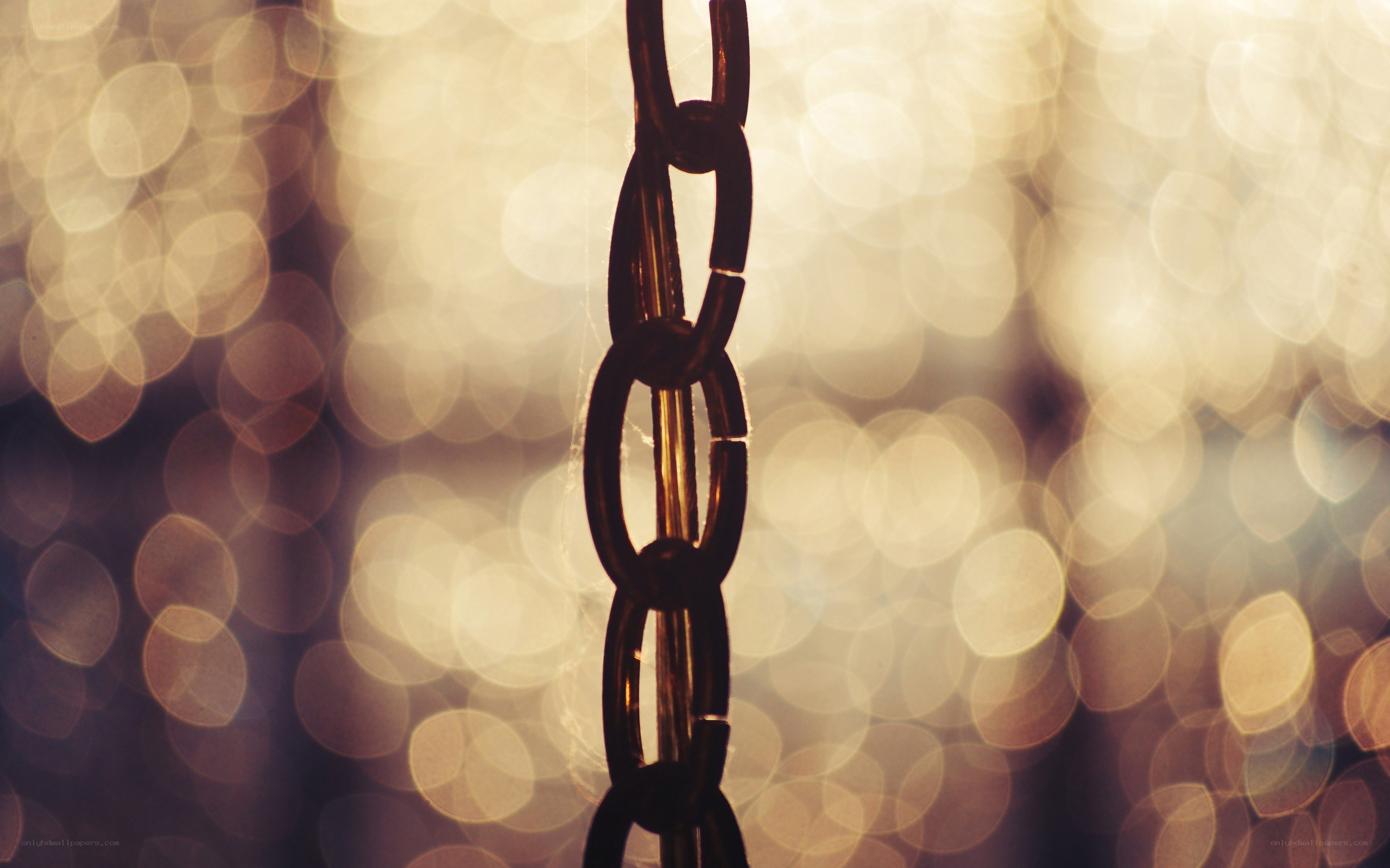 chain against bokeh lights