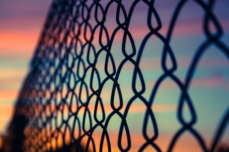 chain-link fence at sunset