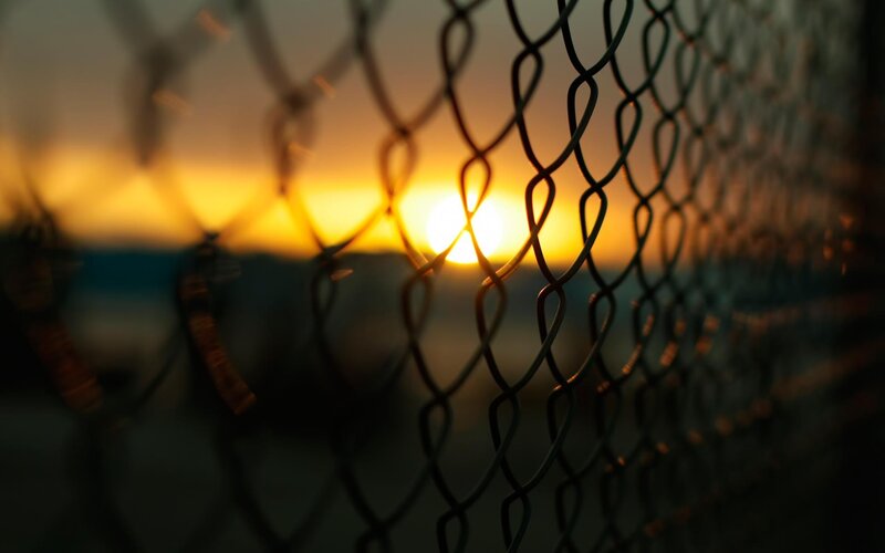 Chain-link Fence at Sunset — Yellow