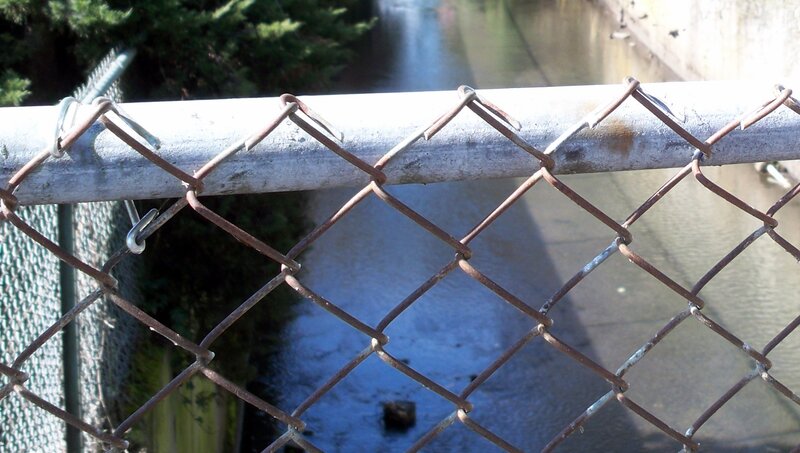 chain-link fence over canal