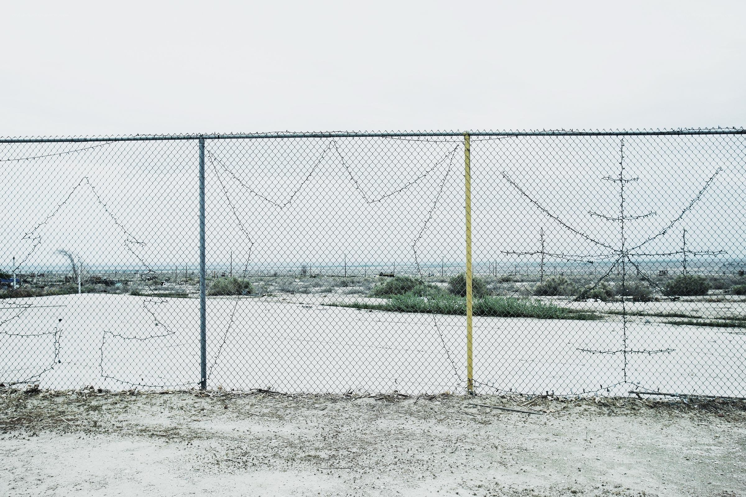 chain-link fence with barbed wire