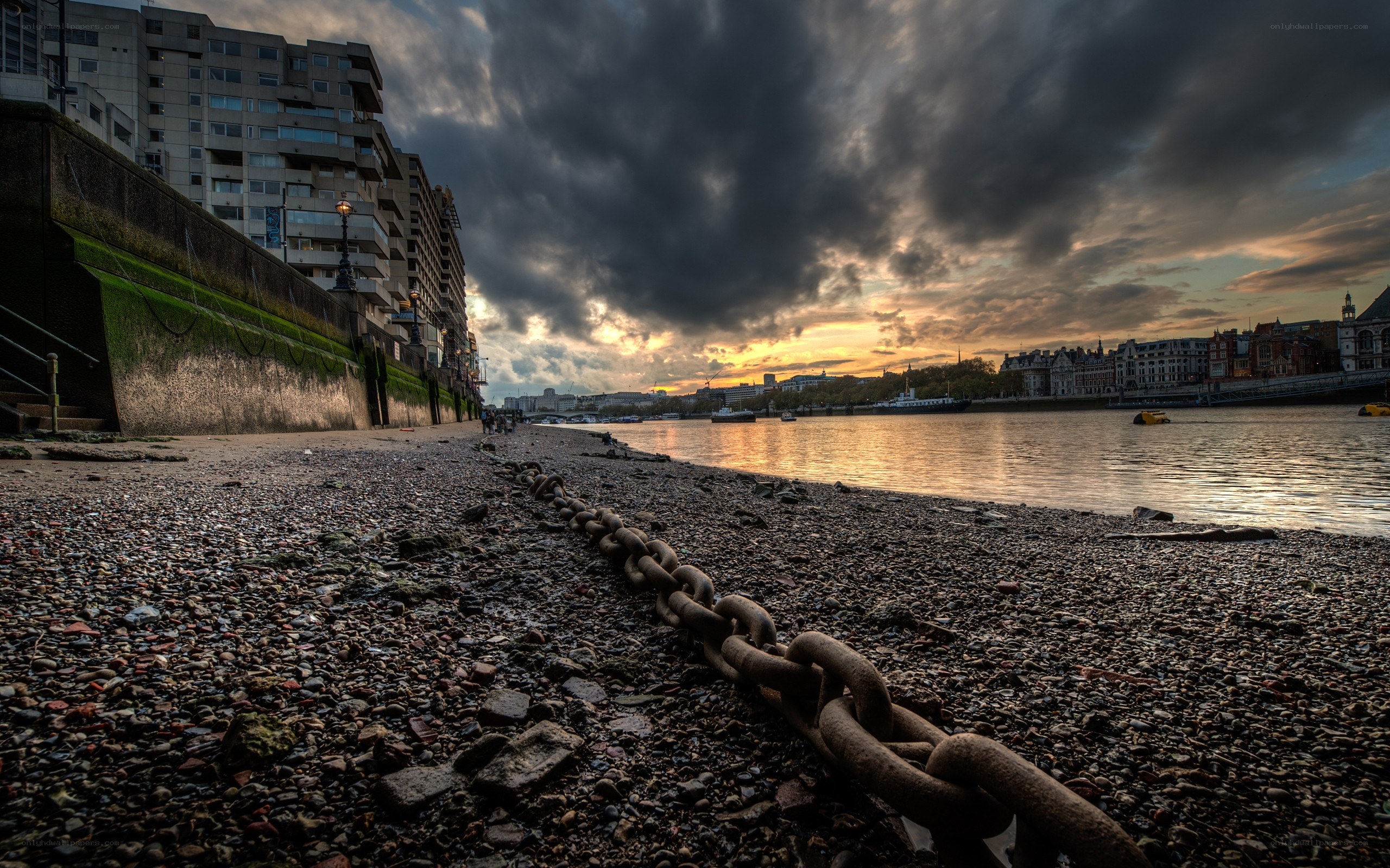 Chain on a pebble beach at sunset