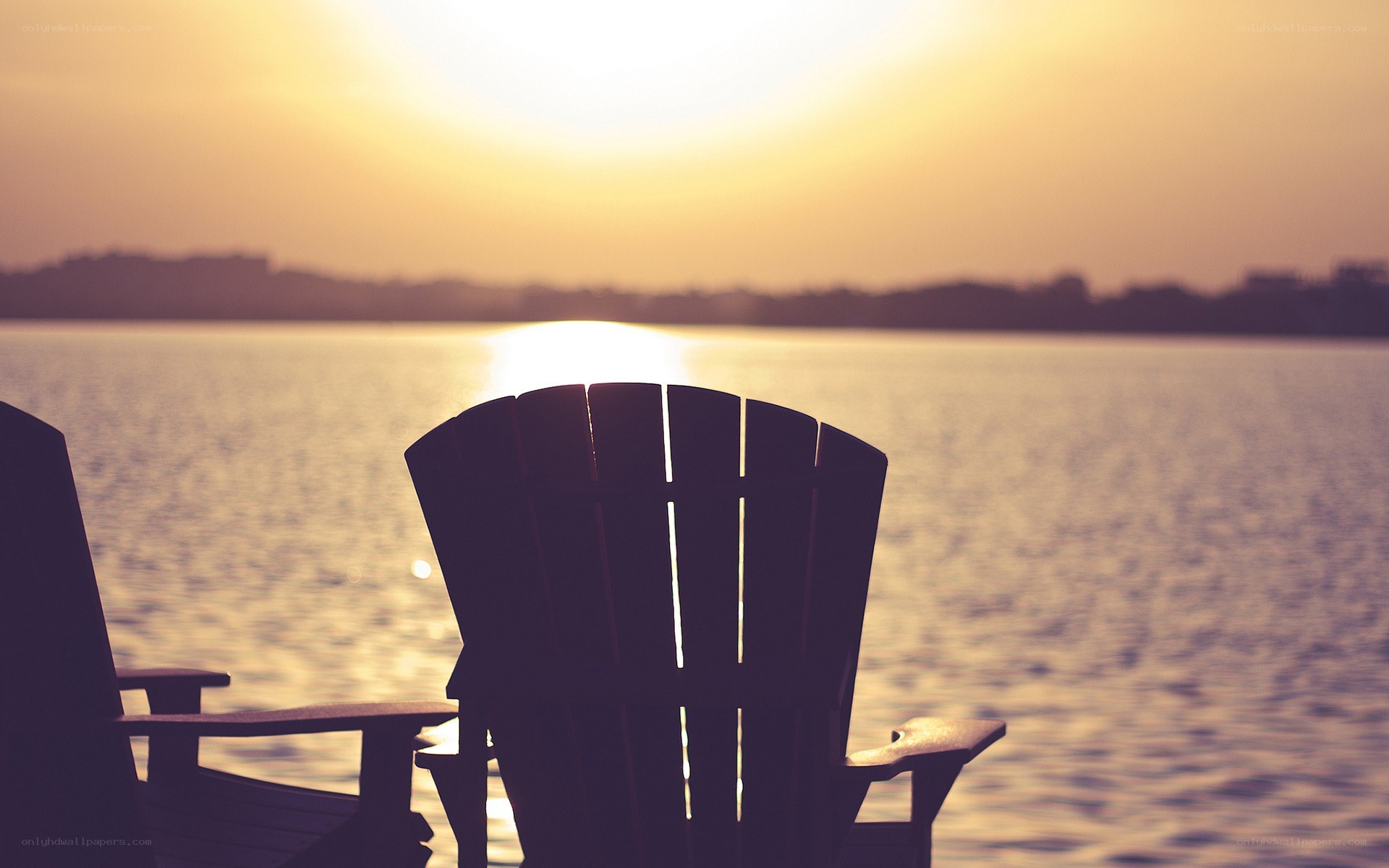 Chairs at sunset by the water