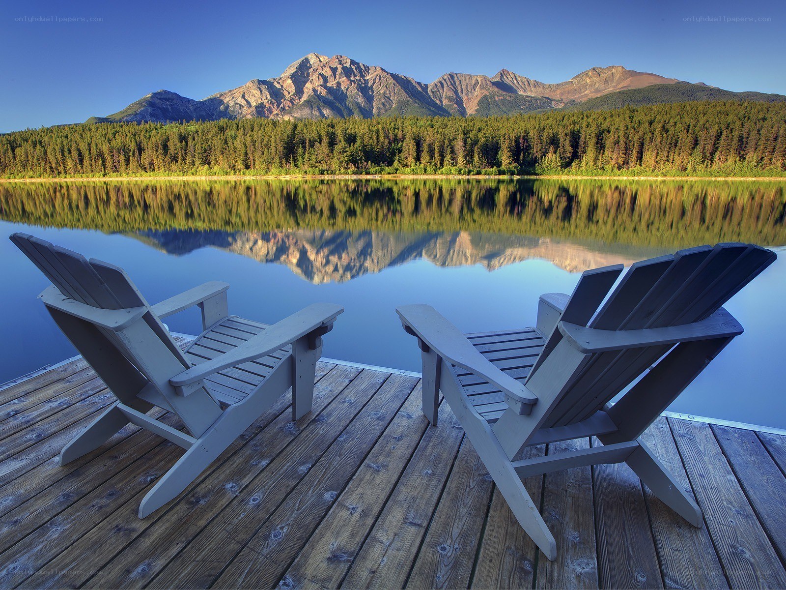 Chairs by a mountain lake