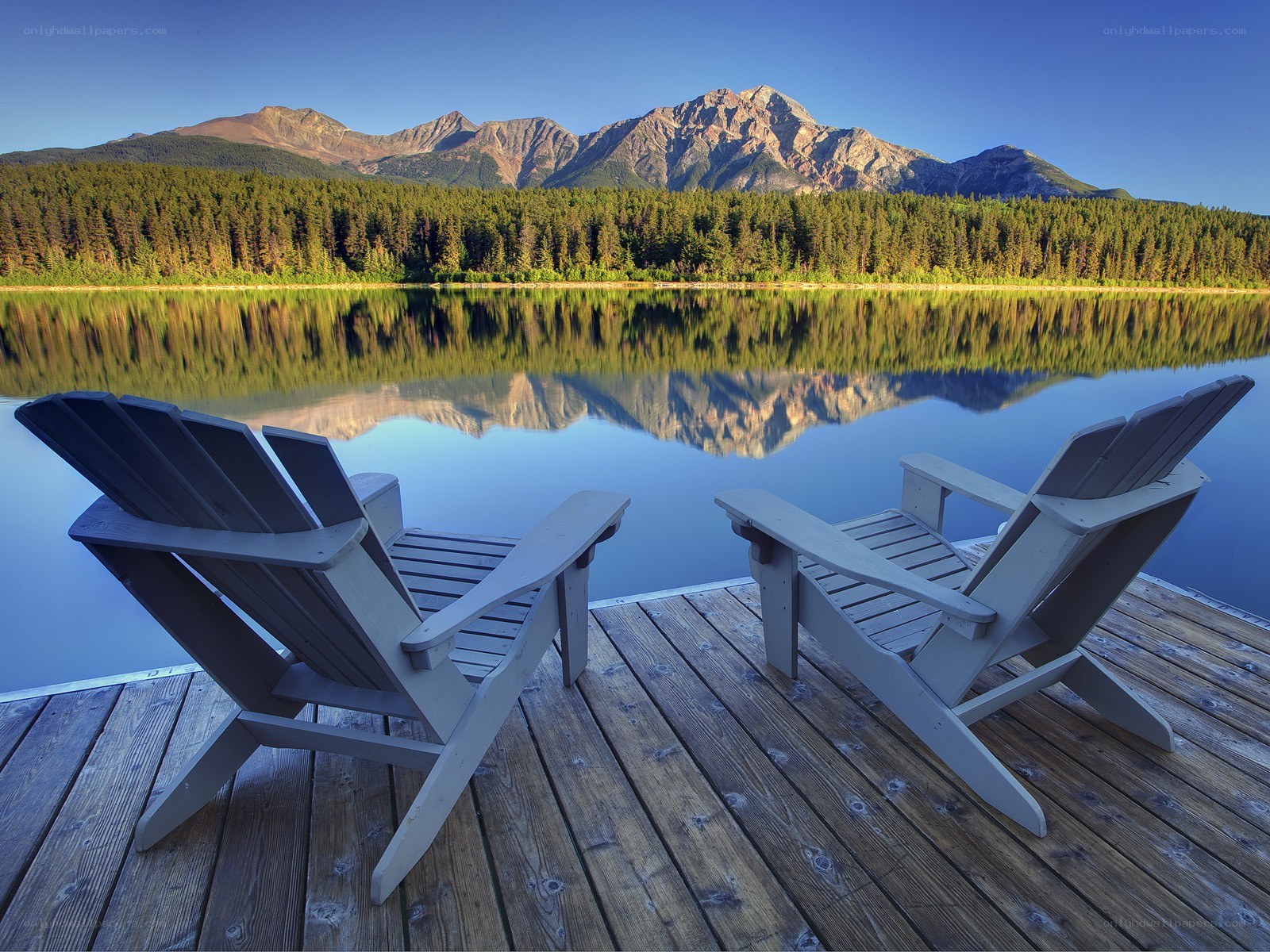 Chairs by a mountain lake