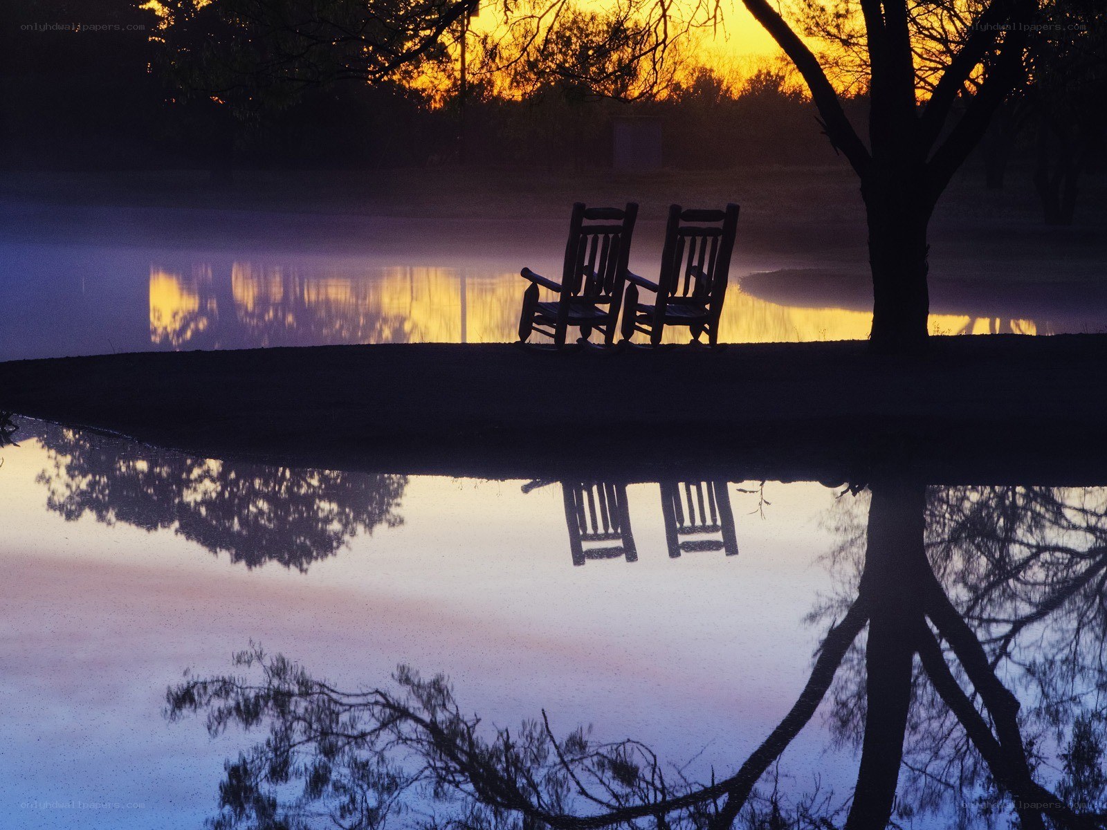 Chairs by the lake at sunset