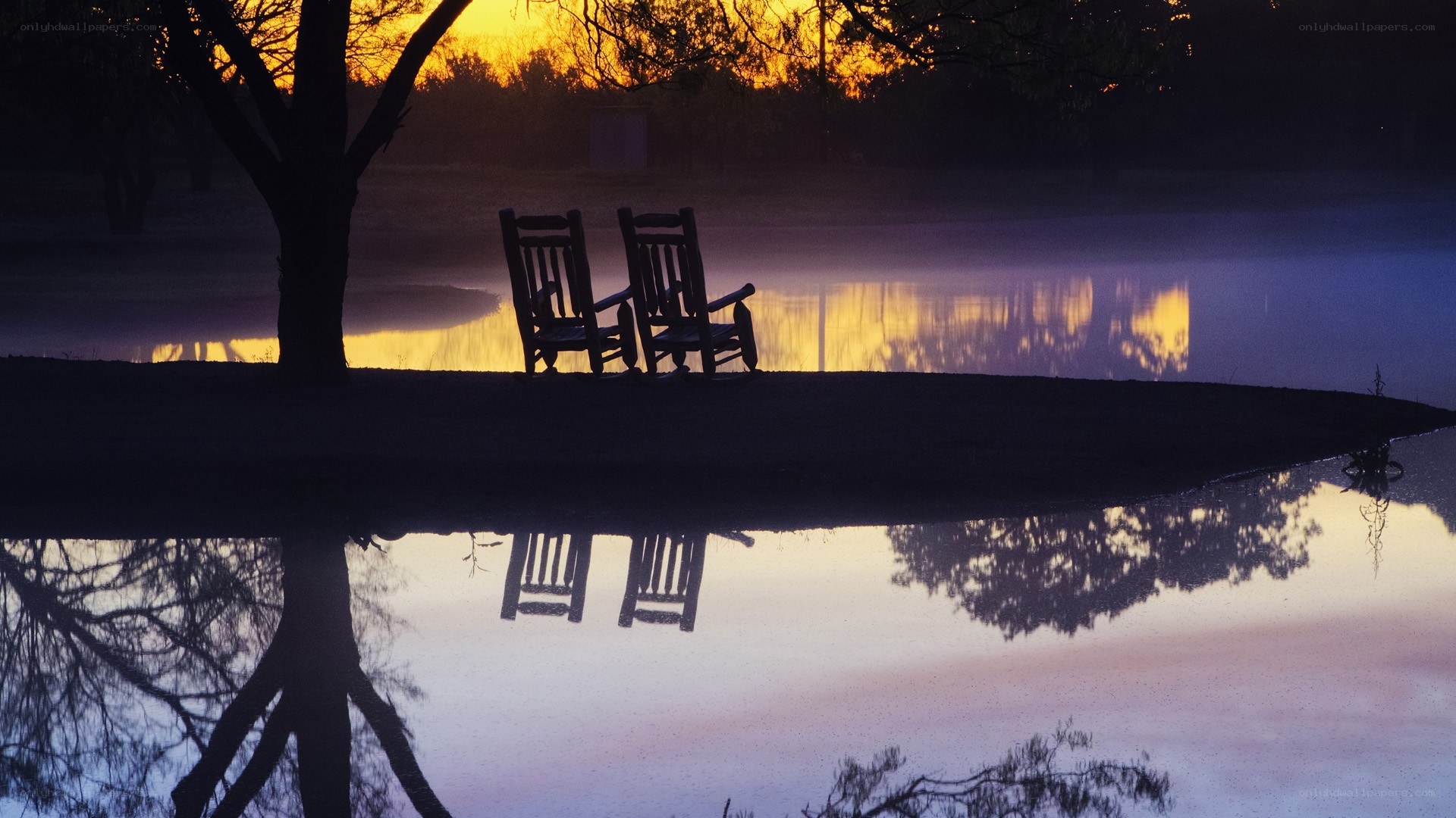 Chairs by the lake at sunset