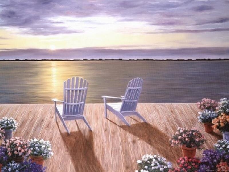 Chairs on a dock at sunset