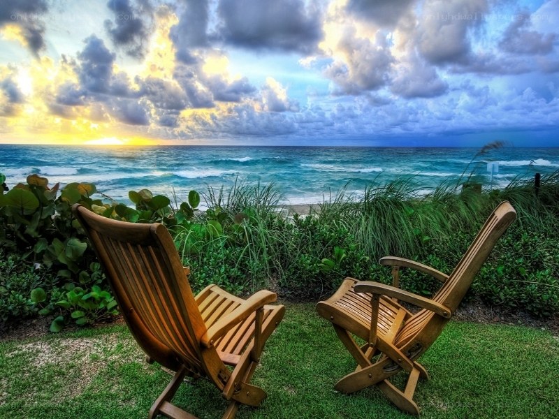 Chairs overlooking ocean sunset