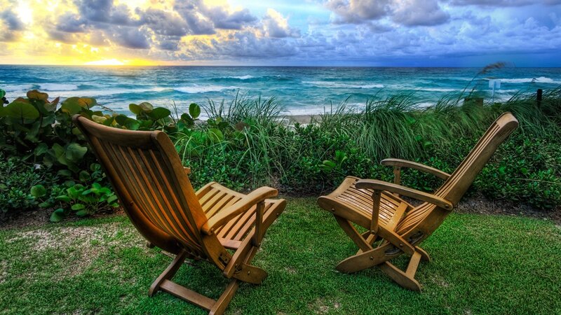 Chairs overlooking the ocean at sunset