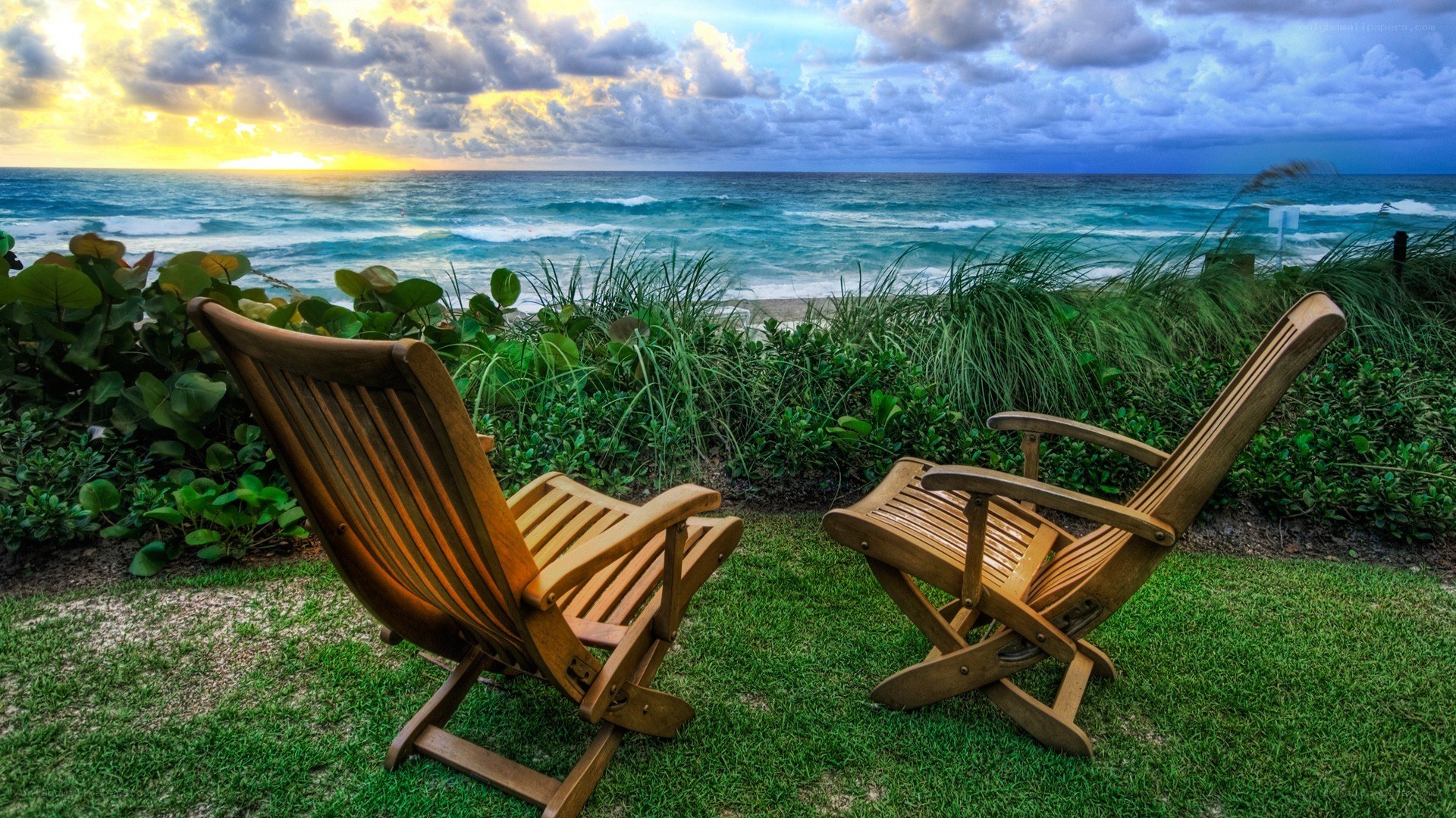 Chairs overlooking the ocean at sunset