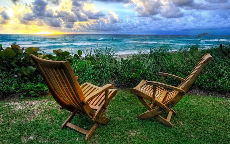 Chairs overlooking the ocean at sunset