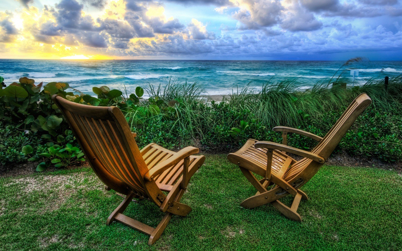 Chairs overlooking the ocean at sunset