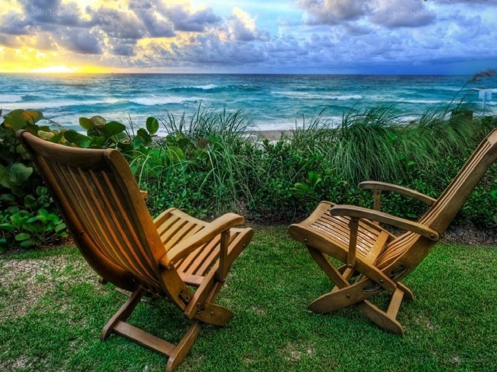 Chairs overlooking the ocean at sunset