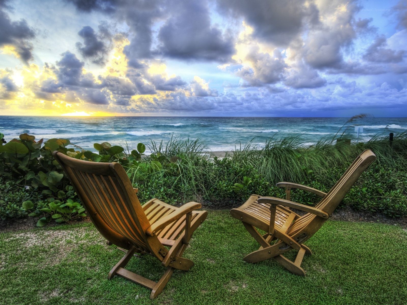 Chairs overlooking the ocean at sunset
