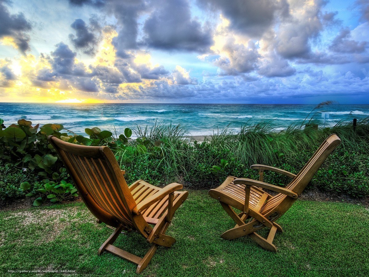 Chairs overlooking the ocean at sunset