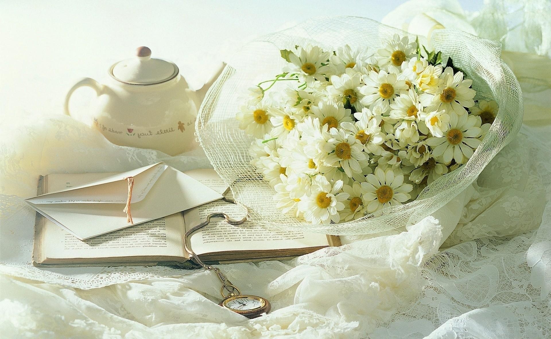 Chamomile bouquet with book and teapot