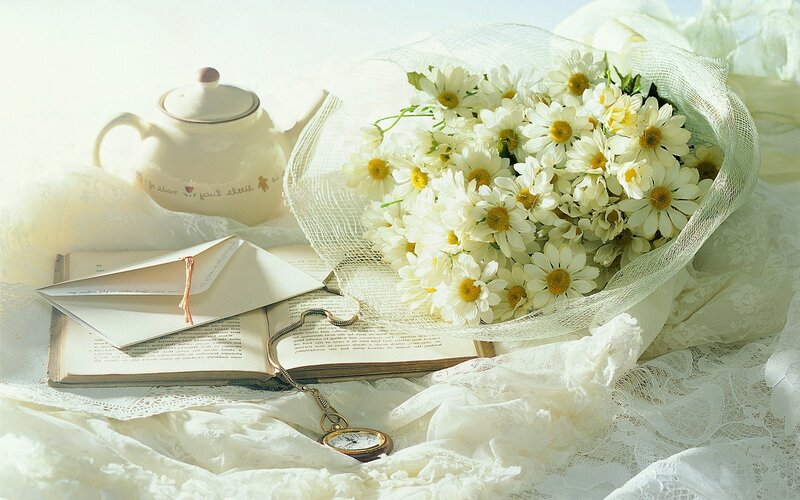 Chamomile bouquet with tea and book
