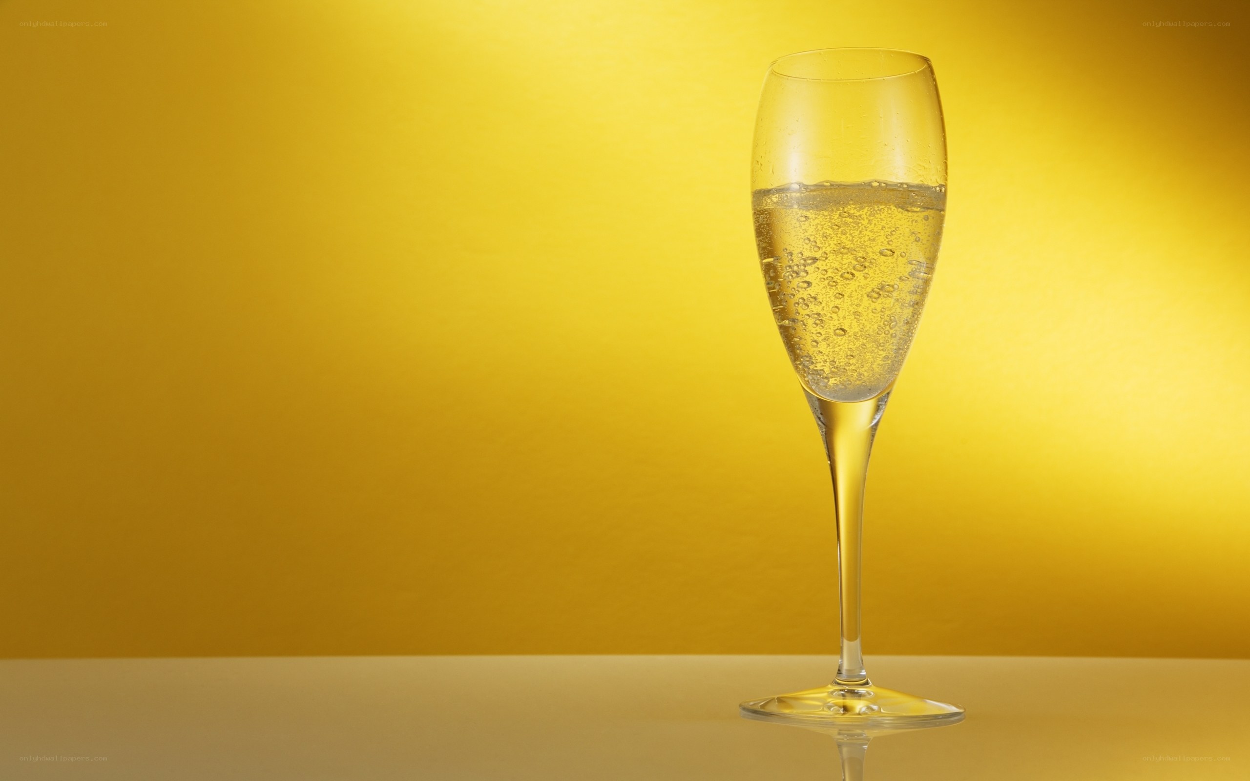 Champagne glass on yellow background