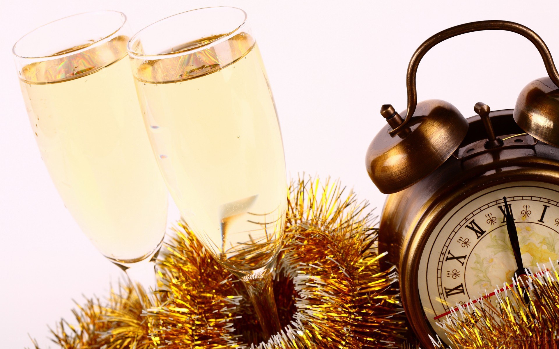 Champagne glasses and alarm clock
