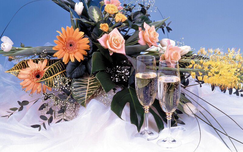 Champagne glasses with floral arrangement