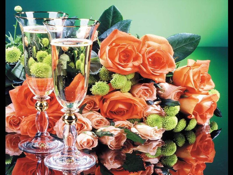 Champagne glasses with orange roses