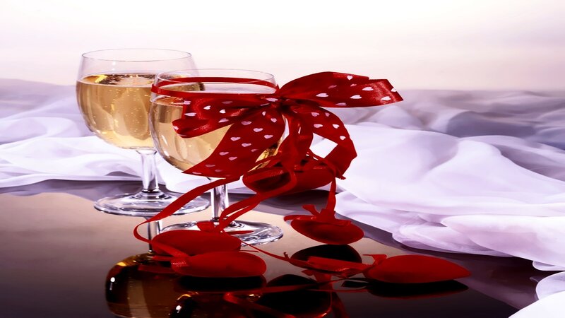 Champagne glasses with red ribbon