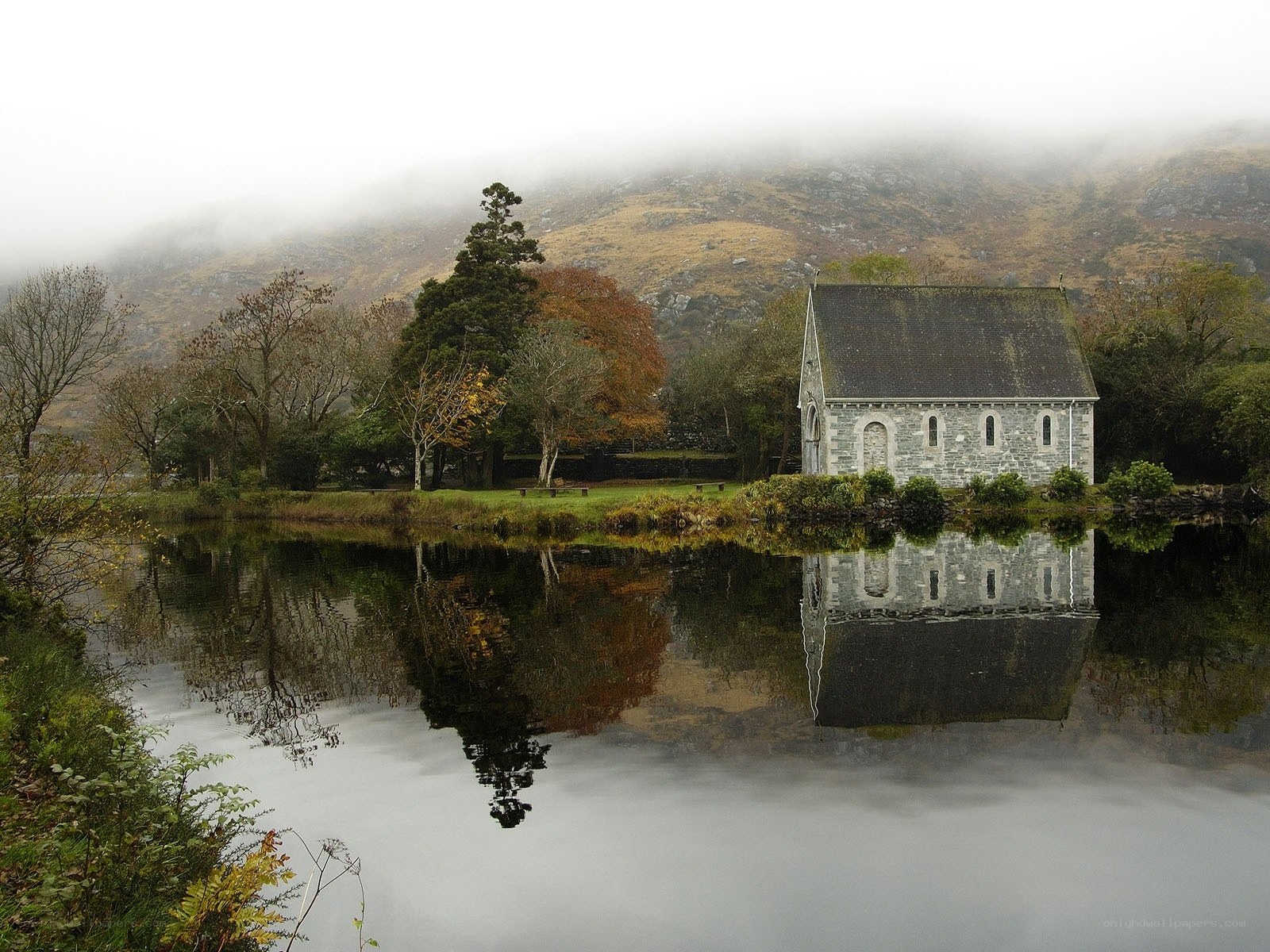Chapel by a misty lake