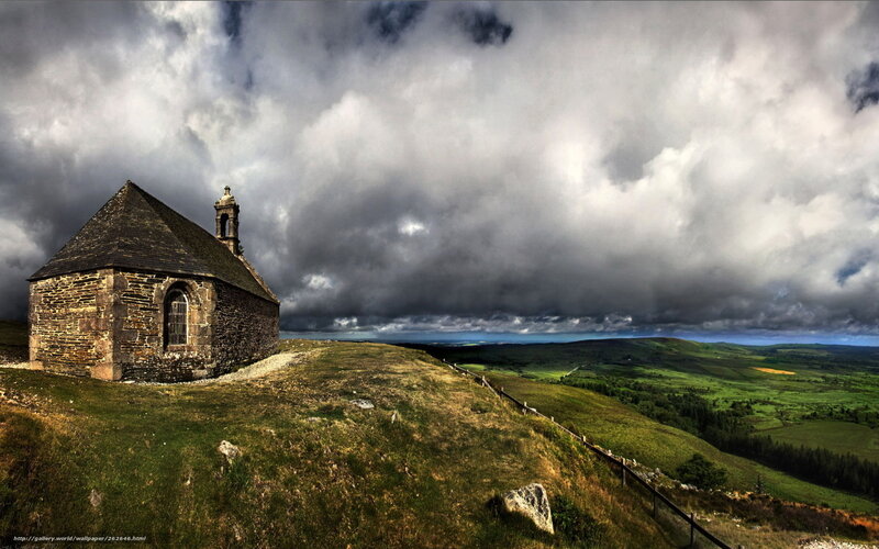 Chapel on a hill under stormy sky