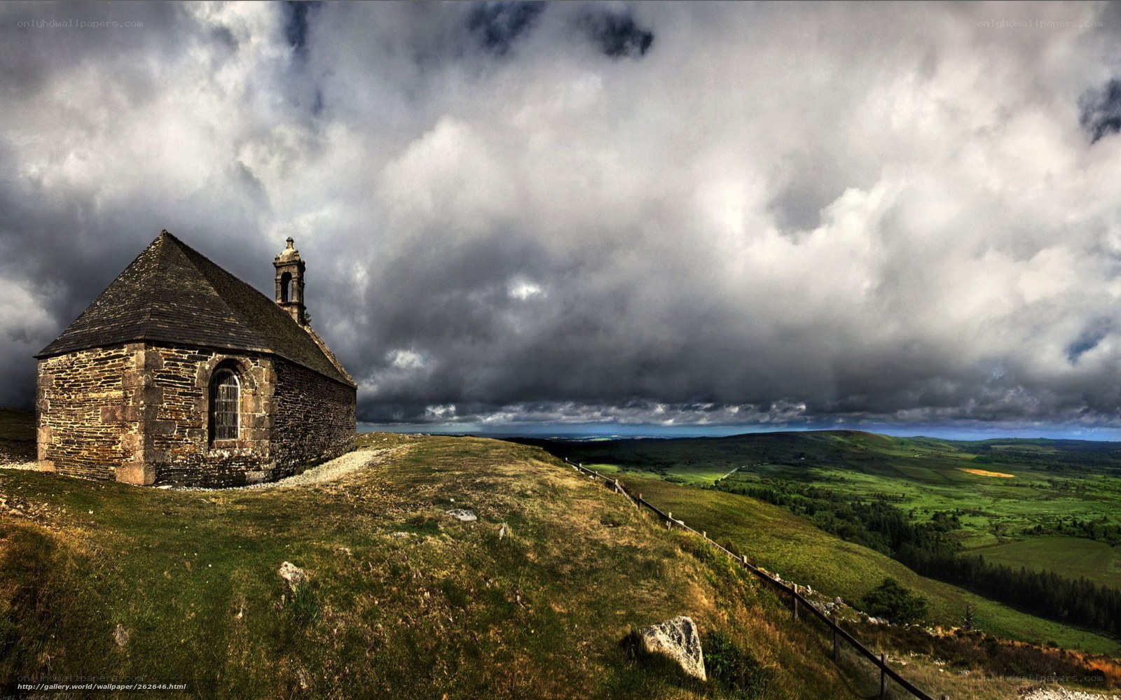 Chapel on a hill under stormy sky