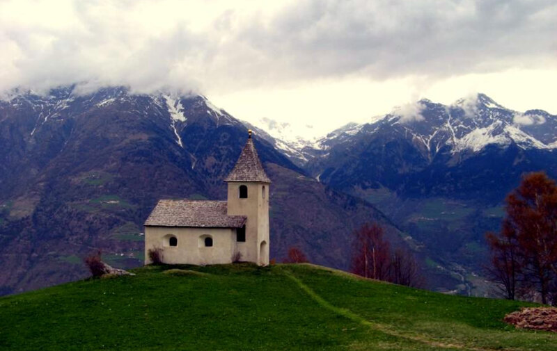 Chapel on a hill with mountains
